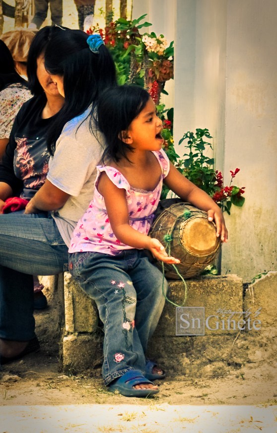 Girl in Camiling practicing for the "tayao" using a traditional musical instrument.