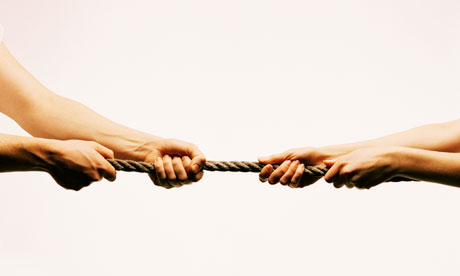 Hands tugging at a rope